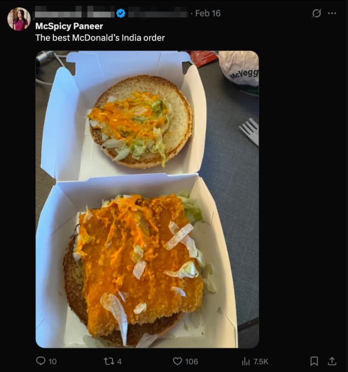 Open McSpicy Paneer burger in a box, showing lettuce and sauce on the patty and bun.