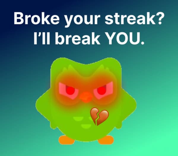 Image of the green Duolingo owl mascot looking very angry, with the caption "Broke your streak? I