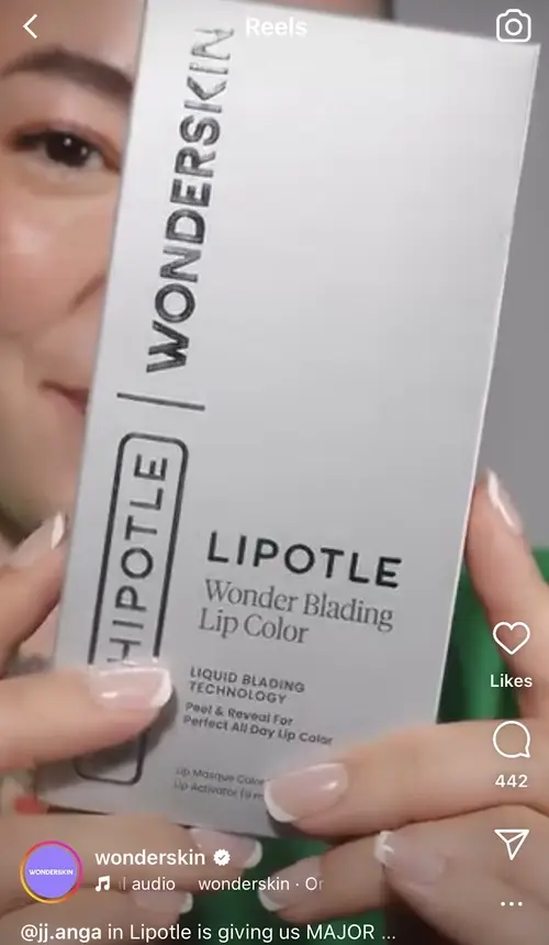 Screenshot of a reel from "wonderskin" of a woman holding a box of Lipotle lip color.