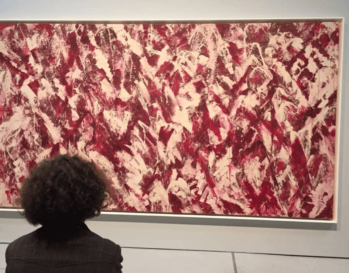A viewer looks at Another Storm, by the artist Lee Krasner